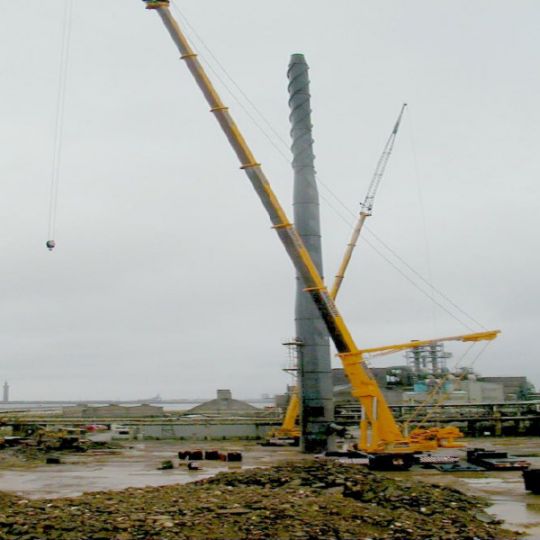 Industrial chimney being prepared for demolition